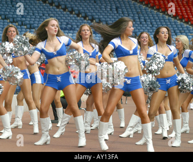 Clad in their famous white bikini tops and mini skirts, the Miami Dolphins  cheerleaders pose with their pom poms prior to their performance during the  2011 KISS Country 99.9 FM Chili Cookoff