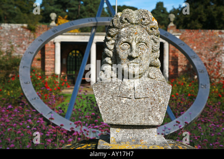 Stone bust of Sir John Flamsteed the first Astronomer Royal at Herstmonceux Castle in Surrey with large sundial behind Stock Photo