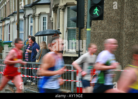 Green running man and London Marathoners Stock Photo