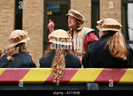 School children listen attentively to an actor aboard the Golden Hind in Southwark Stock Photo