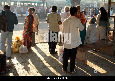 indian passengers waiting at the bus station in mysore by morning light Stock Photo