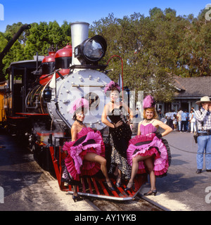 Three Calico Saloon girls standing in front of the Steam Train in the Ghost Town at Knotts Berry Farm – California USA Stock Photo