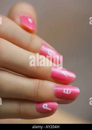 Close-up of the word peace painted on a woman's fingernails Stock Photo