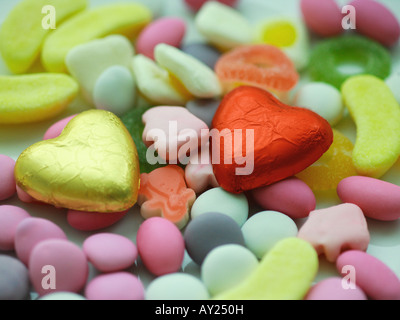 Close-up of two heart shaped chocolates and candy Stock Photo