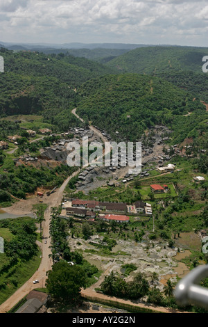 Aerial of environmental damage due illegal gold mining  from Galamsay activity, Prestea school in centre, Ghana Stock Photo