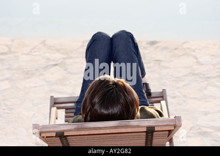 Woman Sitting On Deck Chair At Swimming Pool Sicily Italy Stock Photo