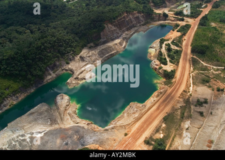 Aerial view of part of surface gold mine concession, showing rehabilitated, replanted old pit and waste dump area, Ghana Stock Photo