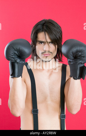 Young Hispanic man wearing boxing gloves Stock Photo