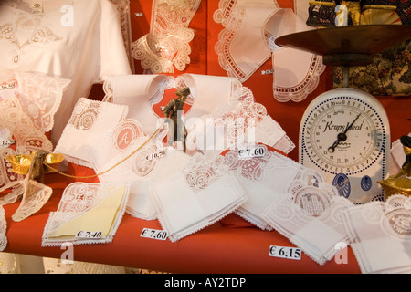 Display of lace and weighing scales in shop window in Brussels, Belgium Stock Photo