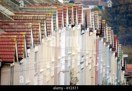 A row of pastel coloured terraced houses switchback over the brow of a hill in Brighton Stock Photo