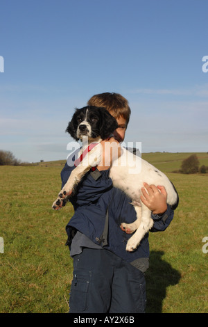 Young boy proudly shows off his new puppy dog Stock Photo