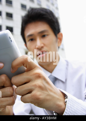Close-up of a businessman using a palmtop Stock Photo