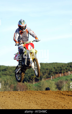 a guy rider on a motocross bile motorcycle jumping and racing big air Stock Photo