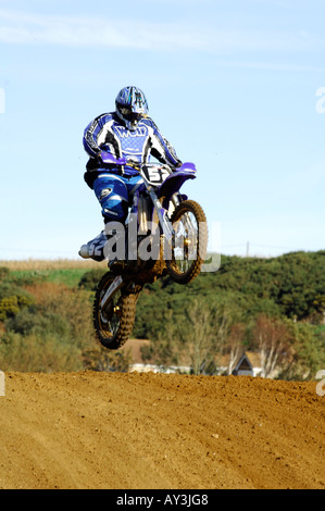 a guy rider on a motocross bile motorcycle jumping and racing big air Stock Photo