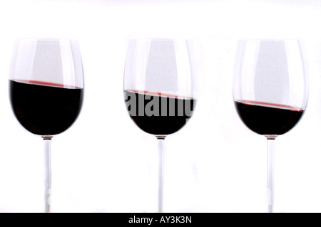 Detail of three glasses of red wine, content slanting / Drei Rotweingläser mit schrägem Inhalt