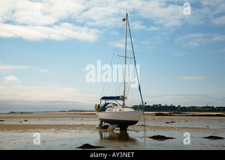 Beached yacht at low tide on 'the Flats' St. Martins Isles of Scilly Cornwall UK Stock Photo