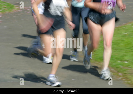 Women runners competing in road race Stock Photo