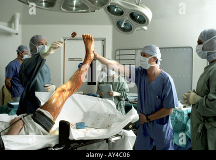 Surgeon preparing patient for knee surgery using iodine