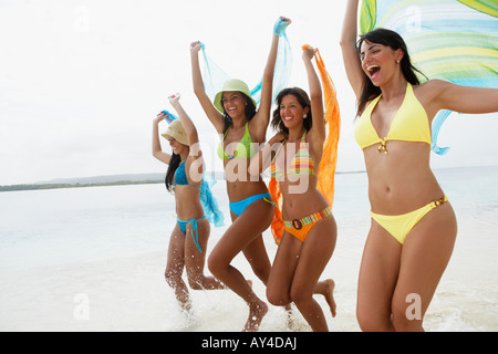 South American women jumping on beach Stock Photo