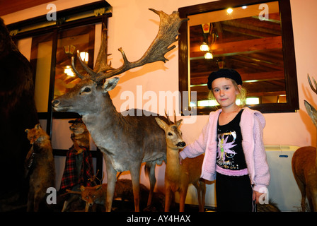 Child standing beside a stuffed deer. Plitvice Lakes National Park, Croatia Stock Photo