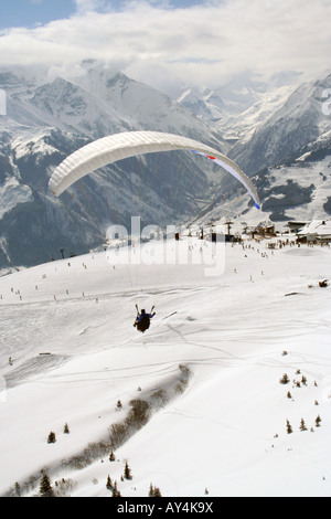Parachutist in Swiss Alps mountains, Crans Montana, Switzerland. Stock Photo