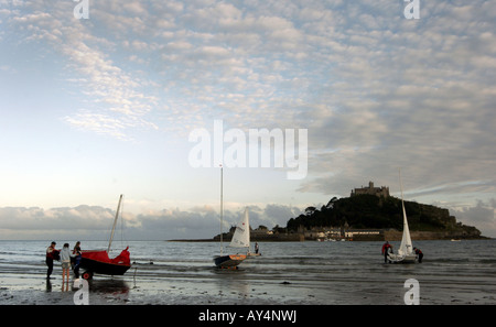 BOATERS WITH THEIR SAILING BOATS ON A SUMMERS EARLY EVENING AT ST MICHAEL'S MOUNT NEAR MARAZION IN CORNWALL,ENGLAND. Stock Photo