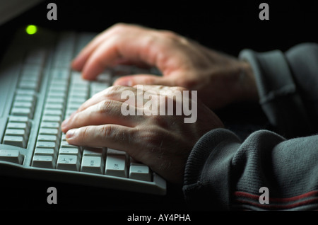 Man using computer hands illuminated by computer monitor Stock Photo ...