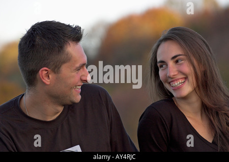 Young couple outdoors laughing Stock Photo