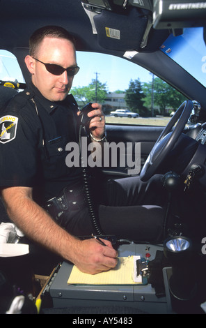 Idaho State Policeman talking on his radio in a police car  Stock Photo