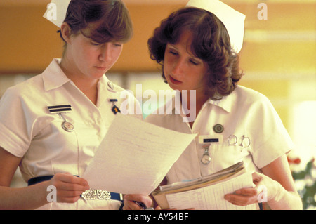 Two nurses discussing patients notes in a hospital ward Stock Photo