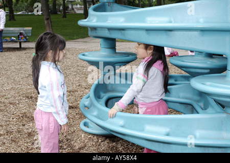 Two 4 year old girls talking on the playground Stock Photo