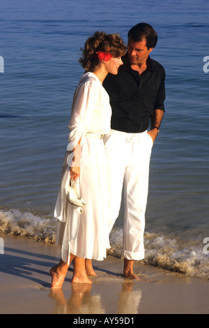 Romantic Couple Walking on Beach Stock Photo