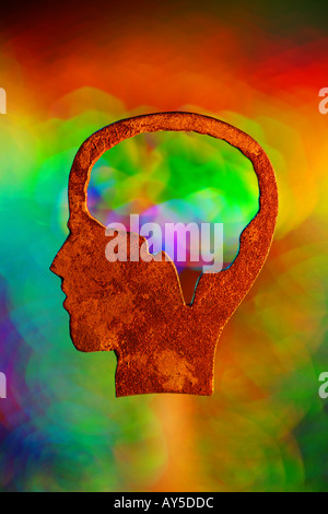 Outline of a head with a focus on the brain Rainbow colored light behind head Psychology concepts aptitude symbolic Stock Photo