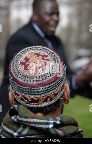 Muslim watching born again evangelical Christian preacher at Speaker s Corner London Stock Photo