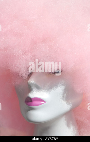 curly pink wig on female dummy head in shop window Stock Photo