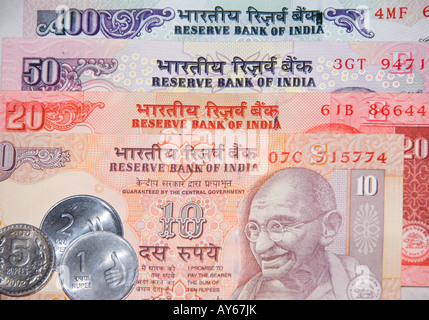 A selection of bank notes and coins of the Indian Rupee the currency of India Stock Photo