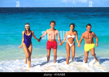 Couples Having Fun in Surf on Caribbean Beach Stock Photo
