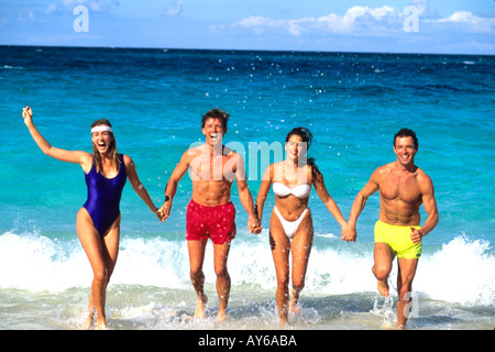 Couples Having Fun in Surf on Caribbean Beach Stock Photo