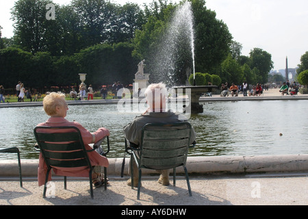 mature couple by round pond in Tuileries Gardens Paris France Stock Photo
