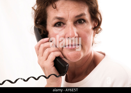 Old woman with telephone Stock Photo