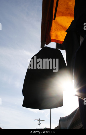 jacket on market clothes stall in morning sun Stock Photo