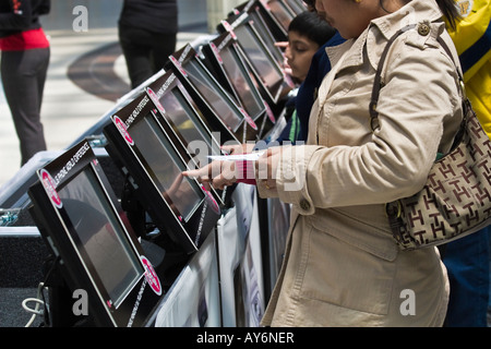 People filling out contest information on touch screen computers Stock Photo