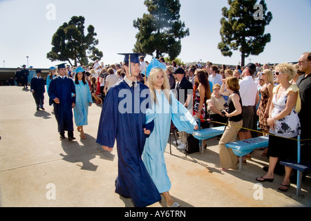 Proud high school seniors march past well wishers during graduation exercises in Huntington Beach CA Stock Photo