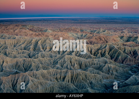 Sunset over Badlands of Anza Borrego Desert State Park in southern California along Mexican border with Salton Sea in background Stock Photo