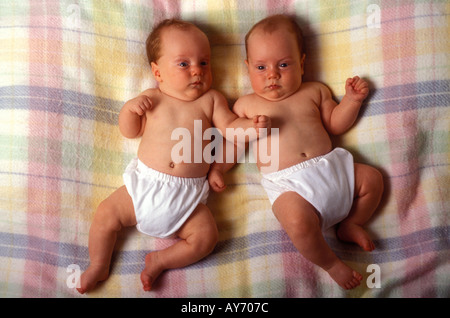 Two twin boys laying on blanket Stock Photo