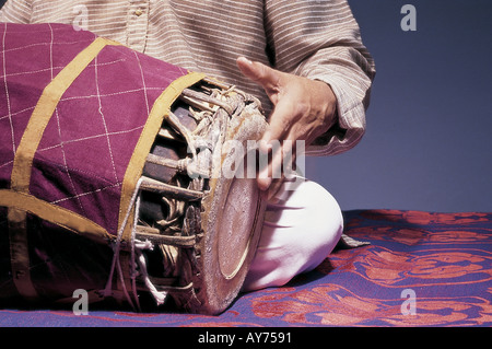 Indian classical music maestro T K Murthy playing with left hand percussion musical instrument Mridangam in concert India Stock Photo