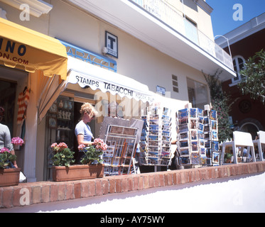 Couple looking at postcards in souvenir shop, Campagnia, Italy Stock Photo