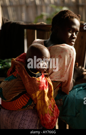 African woman with child baby in sling the Gambia West Africa Stock Photo