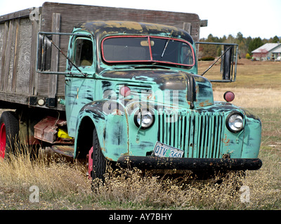 An ancient 1940 s stake truck sits abandoned in a field near Tumalo Reservoir Road Stock Photo