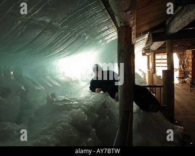 A sheet of ice from the roof Ice covers the deck area a two story cabin at Elk Lake Resort lodge along the Cascade Lakes Highway Stock Photo